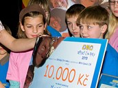 Ewa Farna předává šek na školní pomůcky školákům z Břeclavi.